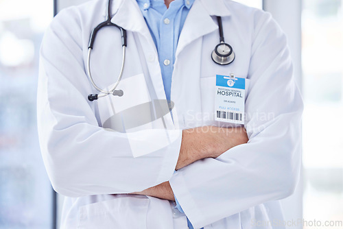 Image of Closeup, man and doctor with arms crossed, healthcare and leadership in hospital. Male, surgeon and medical professional with confidence, leader and ready for surgery procedure, medicine and wellness