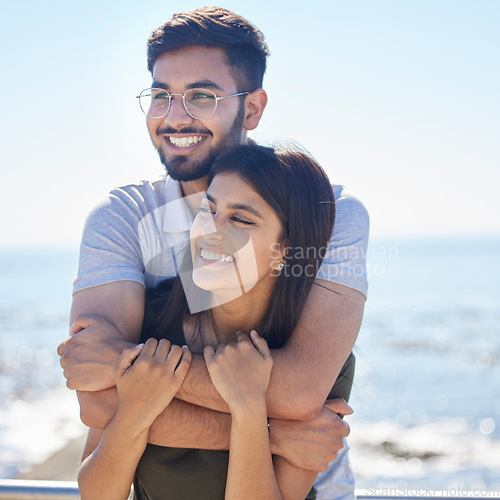 Image of Love, ocean and happy couple hug, relax and enjoy outdoor quality time together for peace, freedom and romantic date. Beach, sea and man and woman bond on fun travel holiday in Rio de Janeiro Brazil