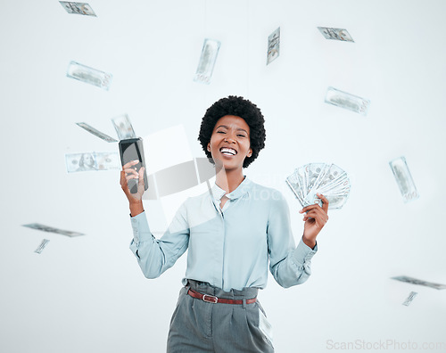 Image of Cash cannon, money rain and wealth with a black woman winner in studio on a gray background. Portrait, winning or finance with a female employee shooting bank notes in celebration of profit