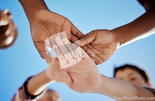 Image of Diversity, stack of hands and children in unity, support or solidarity with a blue sky background. Solidarity, collaboration and multiracial kid friends cheering together for motivation, fun and joy.