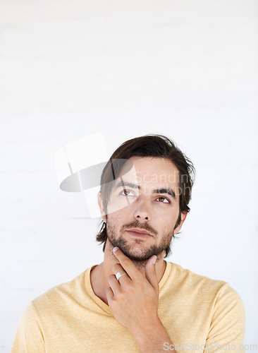 Image of Idea mockup, face and man thinking, pensive and focus on contemplating problem solving plan. Studio marketing space, advertising mock up and model product placement isolated on white background wall