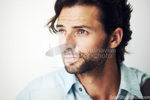 Image of Face, thinking and inspiration with a handsome man on a gray background with blank mockup space. Idea, mock up and beard with a male posing to promote advertising, marketing or product placement