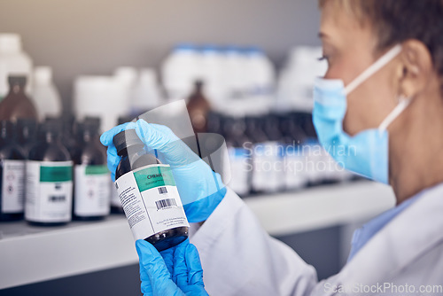 Image of Hand, covid and medical vaccine with a nurse working in a hospital or clinic for treatment in the pandemic. Healthcare, insurance and bottle with a female medicine professional at work during corona