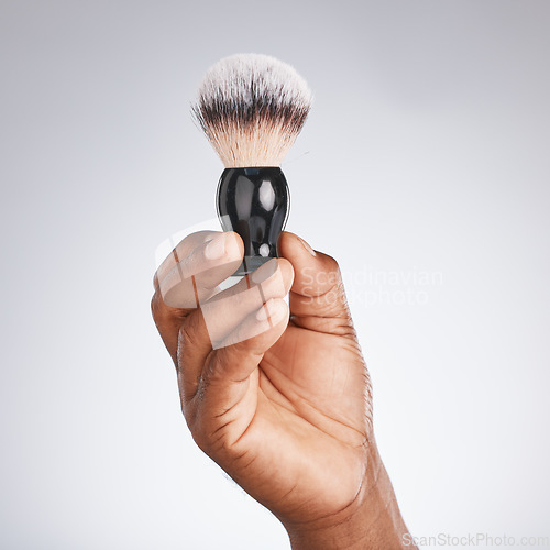 Image of Hand, brush and shaving with beauty and black man, hygiene and grooming with skincare mockup. Shave, body hair care and cosmetic tools marketing with barber equipment against studio background