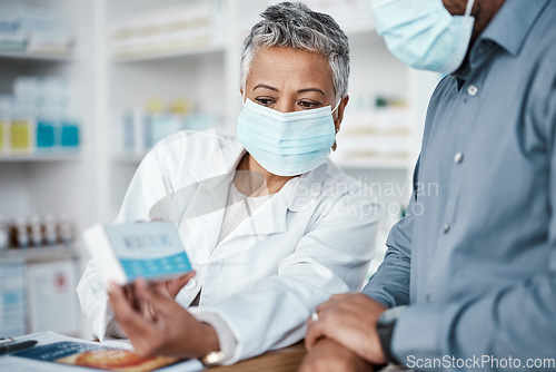 Image of Covid, pharmacy and woman with box consulting patient on prescription, medication or medicine. Corona, healthcare and senior female medical professional showing black man health product in drug store