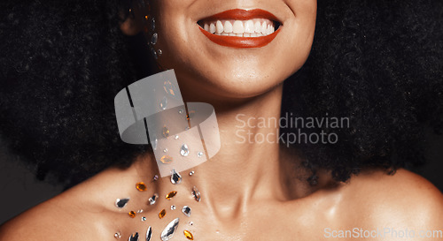 Image of Woman face, fashion jewelry or body art rhinestones on black background studio in festival diamonds sparkle or creative party crystals. Zoom, happy smile or beauty model skin and makeup cosmetic gems