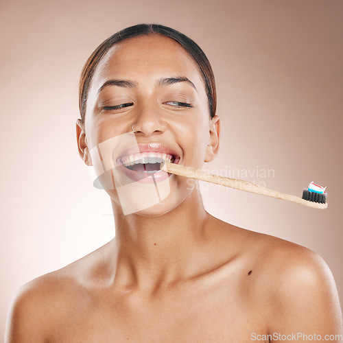 Image of Fun woman, face or toothbrush on studio background in dental care, hygiene grooming or mouth healthcare. Happy smile, beauty model and toothpaste product for brushing teeth or oral cleaning wellness