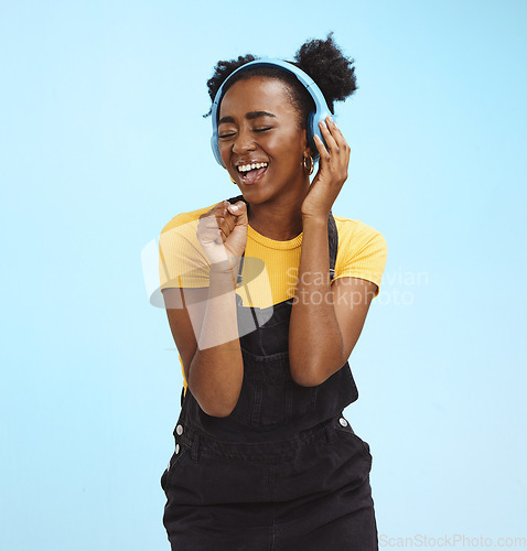 Image of Music, dance and freedom with black woman and headphones, singing for relax, celebration and streaming. Audio, smile and technology with girl listening to online radio for playlist, energy and happy