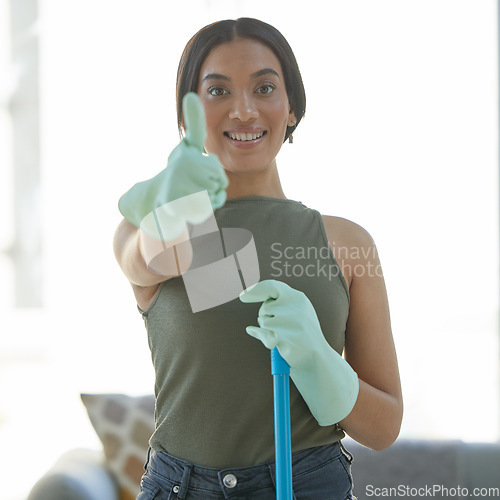 Image of Thumbs up, portrait and happy woman maid cleaning the living room of a house for hygiene, sanitation and health. Success, cleaning service and female cleaner or housewife mop the floor of a home.