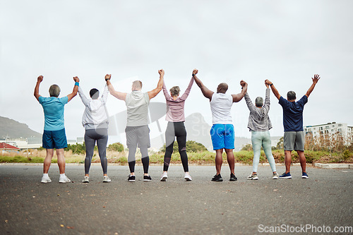 Image of Holding hands, fitness group of people winning, yes or celebration exercise, workout and training goals in city rear. Wellness, community and senior friends teamwork, accountability and success sign