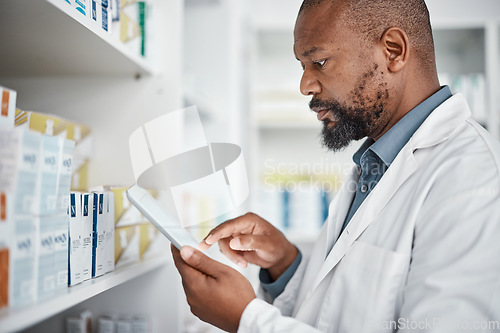 Image of Pharmacy, medicine and black man with tablet to check inventory, stock and medication for online prescription. Healthcare, medical worker and pharmacist with pills, health products and checklist