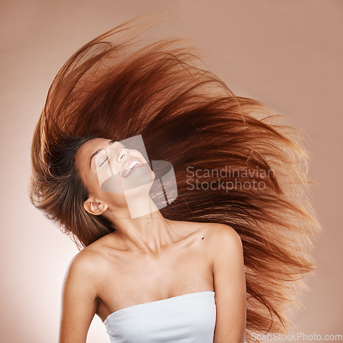 Image of Hair care, wellness and woman in studio with salon, keratin or botox health hair treatment. Cosmetics, happy and female model from Brazil with a long, healthy and brown hair style by brown background