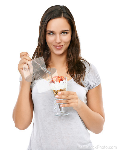 Image of Portrait, diet and nutrition with a woman in studio isolated on a white background while eating muesli for weightloss. Breakfast, health and food with a beautiful young female enjoying a snack