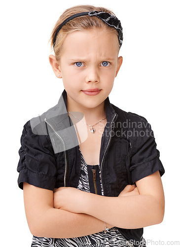 Image of Portrait, angry and children with an unhappy girl standing arms crossed in studio isolated on a white background. Kids, attitude and frown with a female child looking moody, annoyed or frustarted