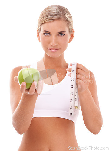 Image of Woman, apple and measure tape in studio portrait for wellness, nutrition or happiness by white background. Isolated model, fruit and goal to lose weight for vitamin c, natural diet or healthy food