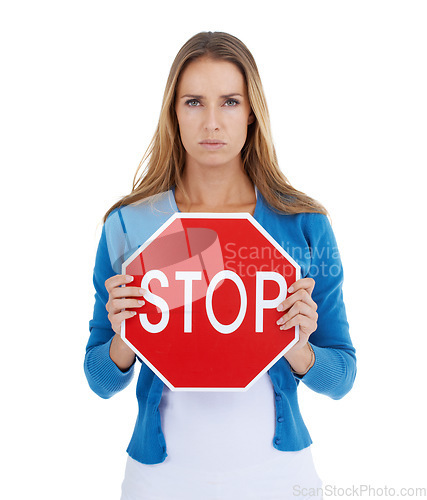 Image of Woman, studio portrait and holding stop sign in hands for serious, assertive or angry face by white background. Activist model, stop and anger for equality, transparency or isolated for woman rights