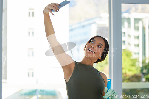 Image of Woman, cleaning service and selfie with phone for digital marketing, social media advertising or a post while in a house or apartment. Female using mobile app while spring cleaning with happiness