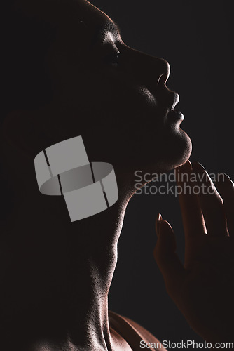 Image of Woman beauty silhouette, face and dark, sexy with cosmetics and seductive fantasy with mysterious aesthetic. Female profile closeup with skin, sexy woman facial against black studio background.