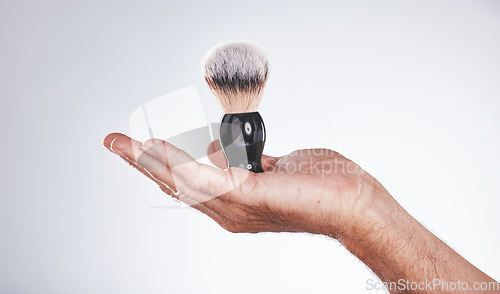 Image of Makeup, cosmetics and hand of man with brush in studio isolated on a gray background mockup. Skincare, aesthetics and male model holding product, accessory or tool for grooming, beauty and wellness.