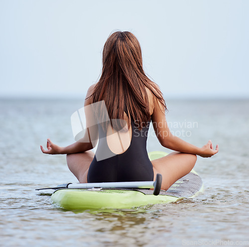 Image of Surfing, yoga and sea meditation of woman with peace, zen and relax energy for fitness, exercise and workout with mindfulness. Lotus, balance and meditate surfer rear in healing, wellness and health