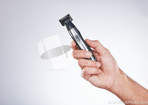 Image of Hand, razor and hair removal with beauty and man with grooming mockup, hygiene and body hair care against studio background. Shaving, electric shaver and cosmetic tools product with face care