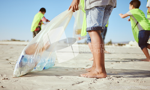 Image of Children, legs or plastic bottles in beach clean up, climate change collection or environment sustainability recycling. Kids, diversity or students in cleaning waste management or community service