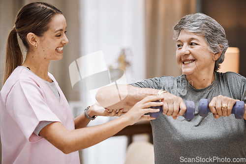 Image of Women, senior or physiotherapy help with dumbbell in wellness clinic, healthcare center or nursing home living room. Smile, happy or physiotherapist nurse and elderly patient in weight rehabilitation