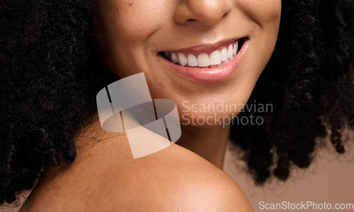 Image of Face beauty, dental and teeth of black woman in studio isolated on a brown background. Skincare, makeup and cosmetics of happy female model with veneers, teeth whitening and invisalign for wellness.