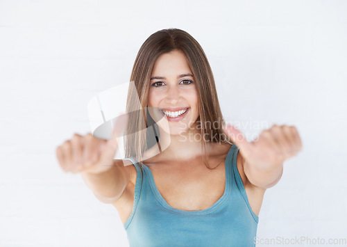 Image of Portrait, young woman and thumbs up for celebration, feedback and lady isolated on white studio background. Female, girl and gesture for success, goal and winner with motivation, wellness or backdrop