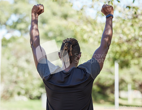 Image of Winner, fitness and black man running outdoor with success, exercise in park with training and active lifestyle. Runner back view, freedom with workout and sports motivation, celebration, win and run