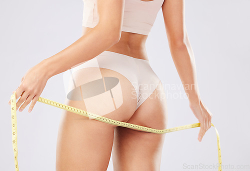 Image of Diet, body and butt of woman with tape measure to track weight loss transformation, check fitness results and measure progress. Health motivation, self care and underwear girl with wellness lifestyle