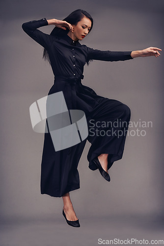 Image of Fitness, martial arts and woman jump in studio isolated on a gray background. Tai chi sports, karate meditation or young female fighter jumping in air getting ready for workout, exercise or training