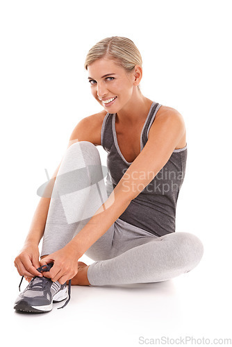 Image of Fitness, portrait and woman tie shoes for training, smile and workout for wellness, health and girl isolated on white studio background. Female athlete, lady or runner tying sneaker lace and exercise