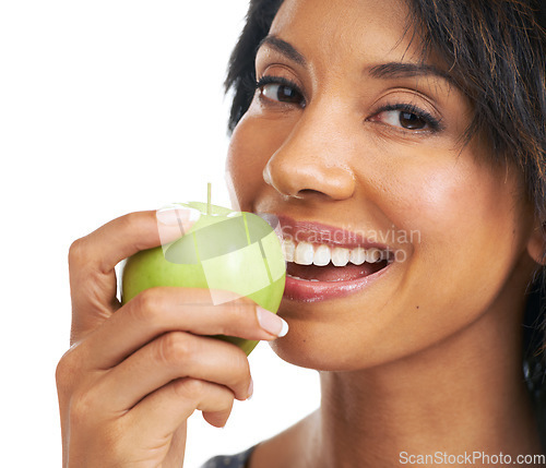 Image of Apple, teeth and woman eating in studio for health, wellness and vegan diet with food or fruits promotion. Healthcare, self care and black woman with fruit choice for nutrition in a portrait smile