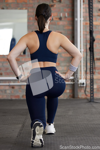 Image of Woman, stretching legs and workout in gym for health, self care and muscle development on floor. Girl, fitness and exercise with lunge, balance or healthy with focus, body goals and vision in Toronto