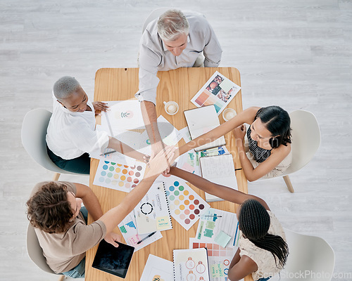 Image of Team work, hands or creative business people in a meeting planning a logo, branding or marketing color on paper. Designers, top view or employees working with senior manager on strategy or kpi goals