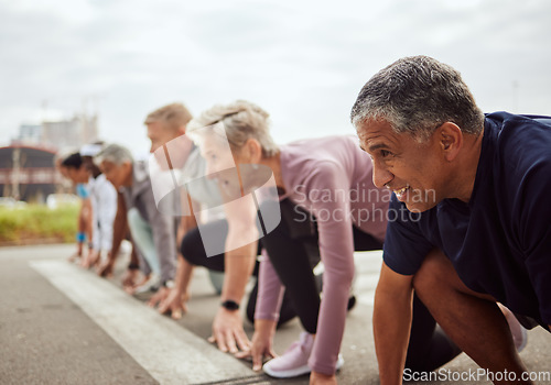 Image of Start, fitness or senior people in a marathon race with running goals in workout or runners exercise. Motivation, focus or healthy group of sports athletes ready for contest on street road in city