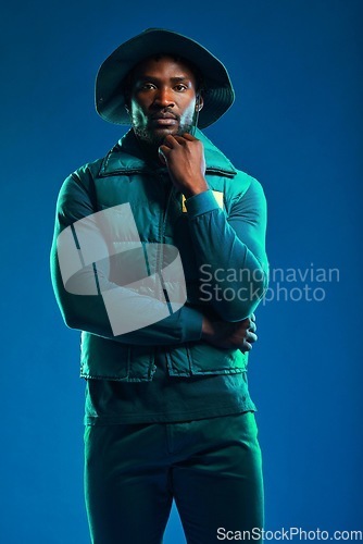 Image of Fashion, style and portrait of black man on blue background with cool, trendy and stylish outfit. Creative, lifestyle clothing and male model pose in studio with designer, modern and edgy clothes