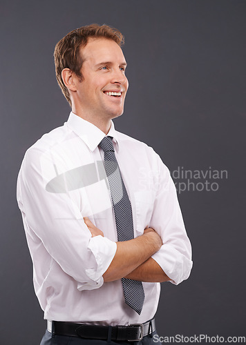 Image of Thinking, vision and mindset with a business man in studio on a gray background for advertising or marketing. Idea, growth or future mission with a handsome male employee standing arms crossed indoor