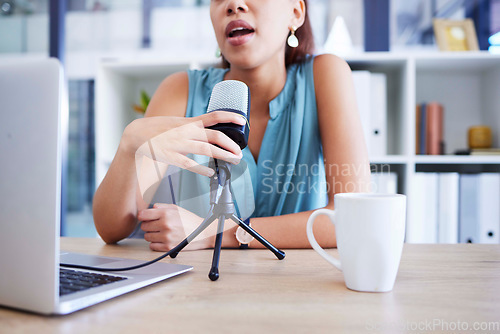 Image of Microphone, influencer and radio with a woman presenter using a laptop to live broadcast while streaming in her home office. Podcast, news and network with a female freelance worker sitting at a desk