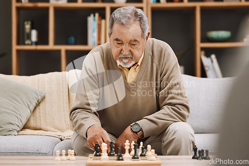 Image of Senior man, thinking or playing chess in house, home living room or apartment in Japanese strategy, checkmate or board game contest. Retirement elderly, smart person or chessboard challenge for mind