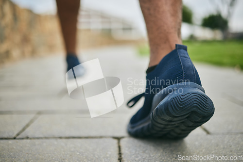 Image of Running shoes, exercise and fitness with feet of a man outdoor on a pavement for a cardio workout. Athlete runner with sneakers for sports training for health, wellness and a healthy lifestyle