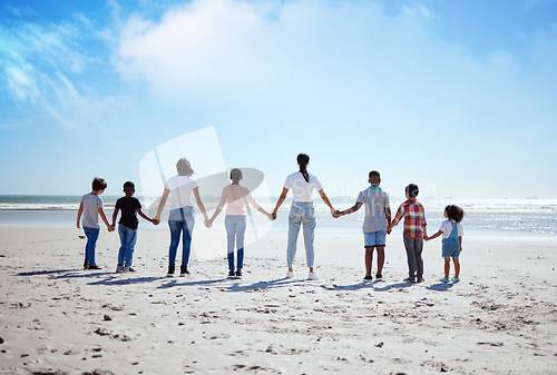 Image of Support, back and big family holding hands at the beach, summer walking and travel holiday in nature of Portugal. Hope, love and women with affection for adopted kids on a vacation at the ocean