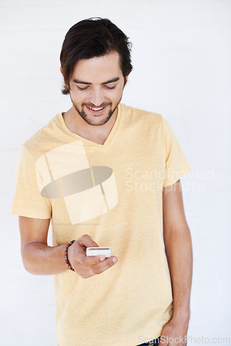 Image of Phone, communication and man on technology typing a cellphone text with isolated white background. Mobile conversation, model and smile of a person with a mobile phone texting with technology