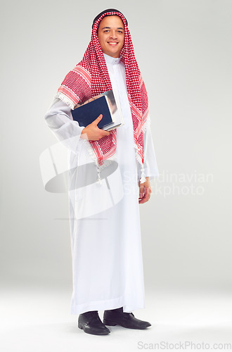 Image of Portrait, Islamic man and books for education, knowledge and guy isolated on white studio background. Muslim, male and student with journals, smile and confident for studying, learning and university