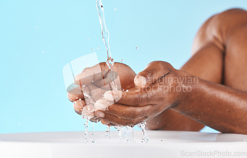 Image of Water splash, hands and cleaning with beauty and black man, hygiene zoom and hydration with water mockup. Clean water drops, splash and skincare with natural cosmetics against blue studio background