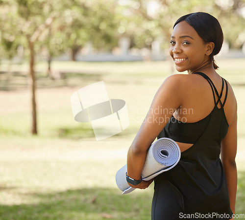 Image of Portrait of black woman in park with yoga mat and from back, smile in nature for health and fitness mindset. Nature, zen and yoga, happy face on woman from behind ready for pilates workout on grass.