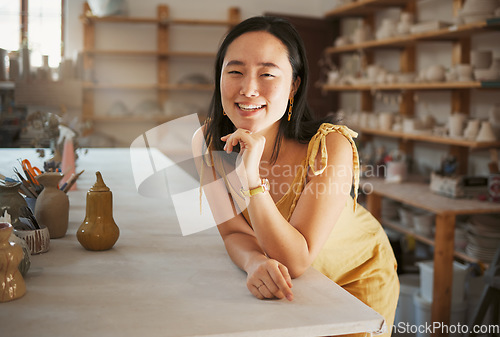 Image of Asian woman, smile portrait and ceramic art studio for product manufacturing workshop, sculpture artist and creativity retail store. Pottery, artistic woman business and creative artwork happiness