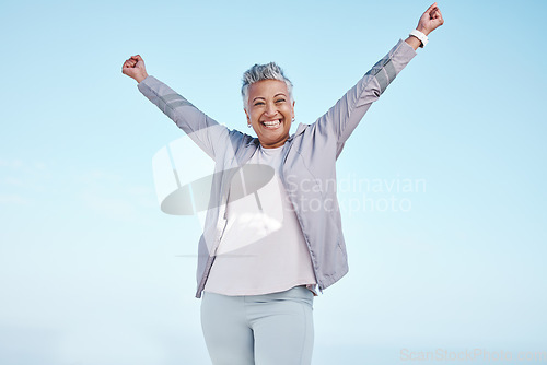 Image of Excited senior woman with hands in air for exercise, fitness or workout portrait goals, success and achievement on blue sky mockup. Winner, freedom and healthy celebration of elderly runner in nature