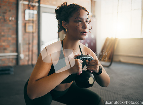 Image of Exercise, kettlebell and a woman at gym breathing during workout, exercise and weight training for body wellness. Strong sports female or athlete with weights for power, muscle and healthy lifestyle